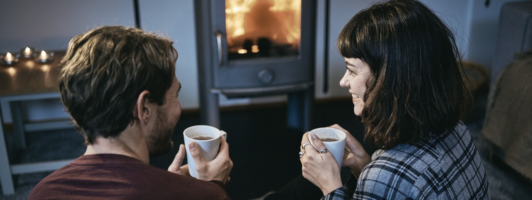 Couple sitting in front of fire
